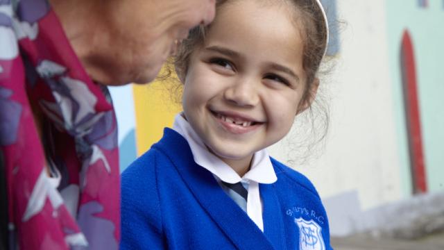 Little girl smiling with reading helper